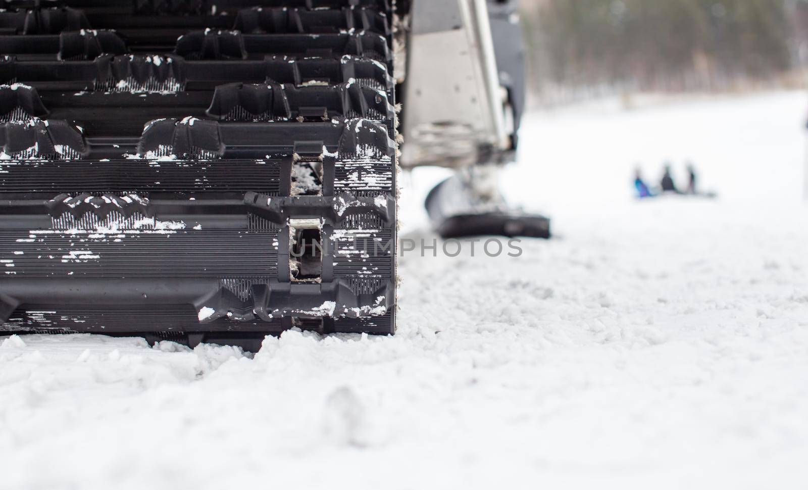 The back of the snowmobile in winter. Riding in the snow on a snowmobile. Rear suspension of a snowmobile