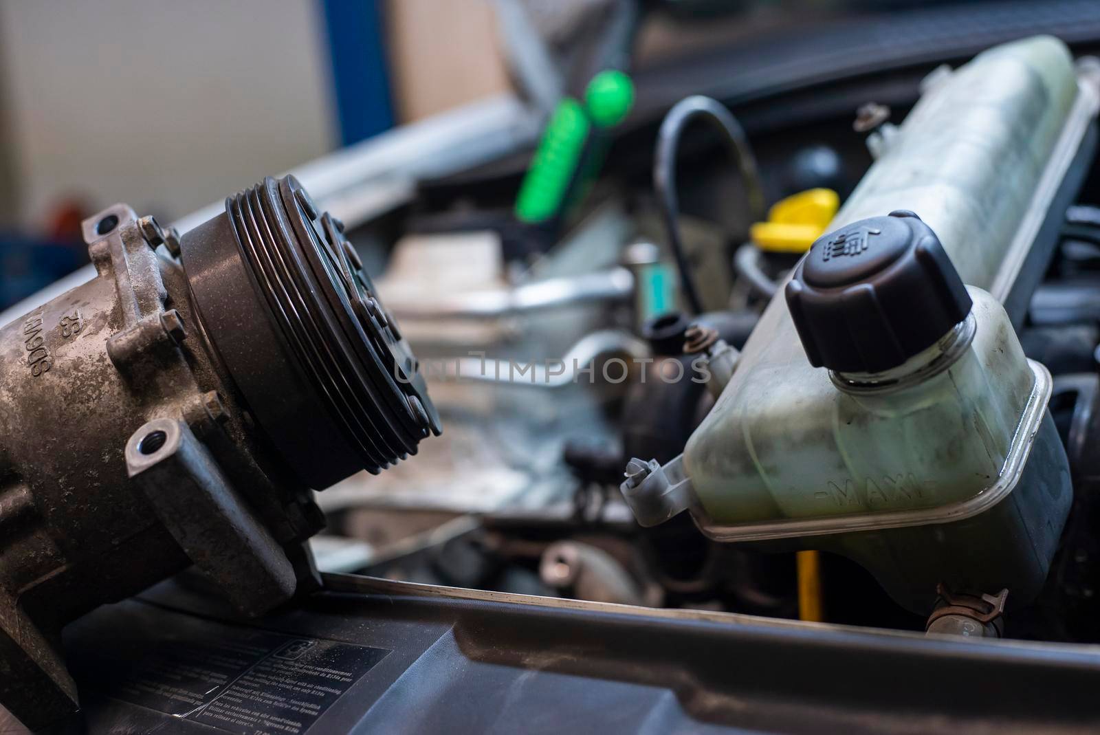 Automobile engine with disassembled parts in a Workshop