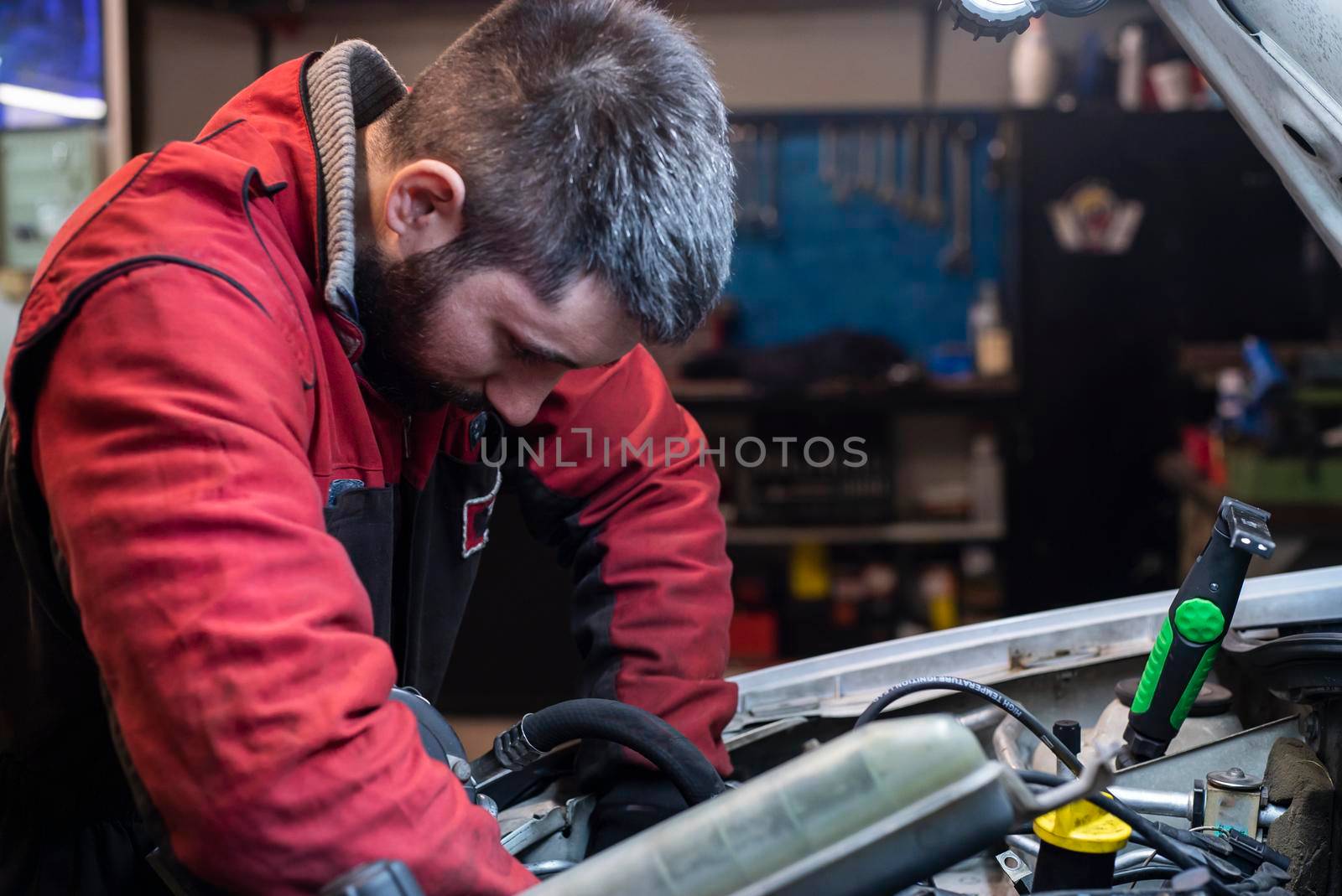 Mechanic working on the engine in the workshop