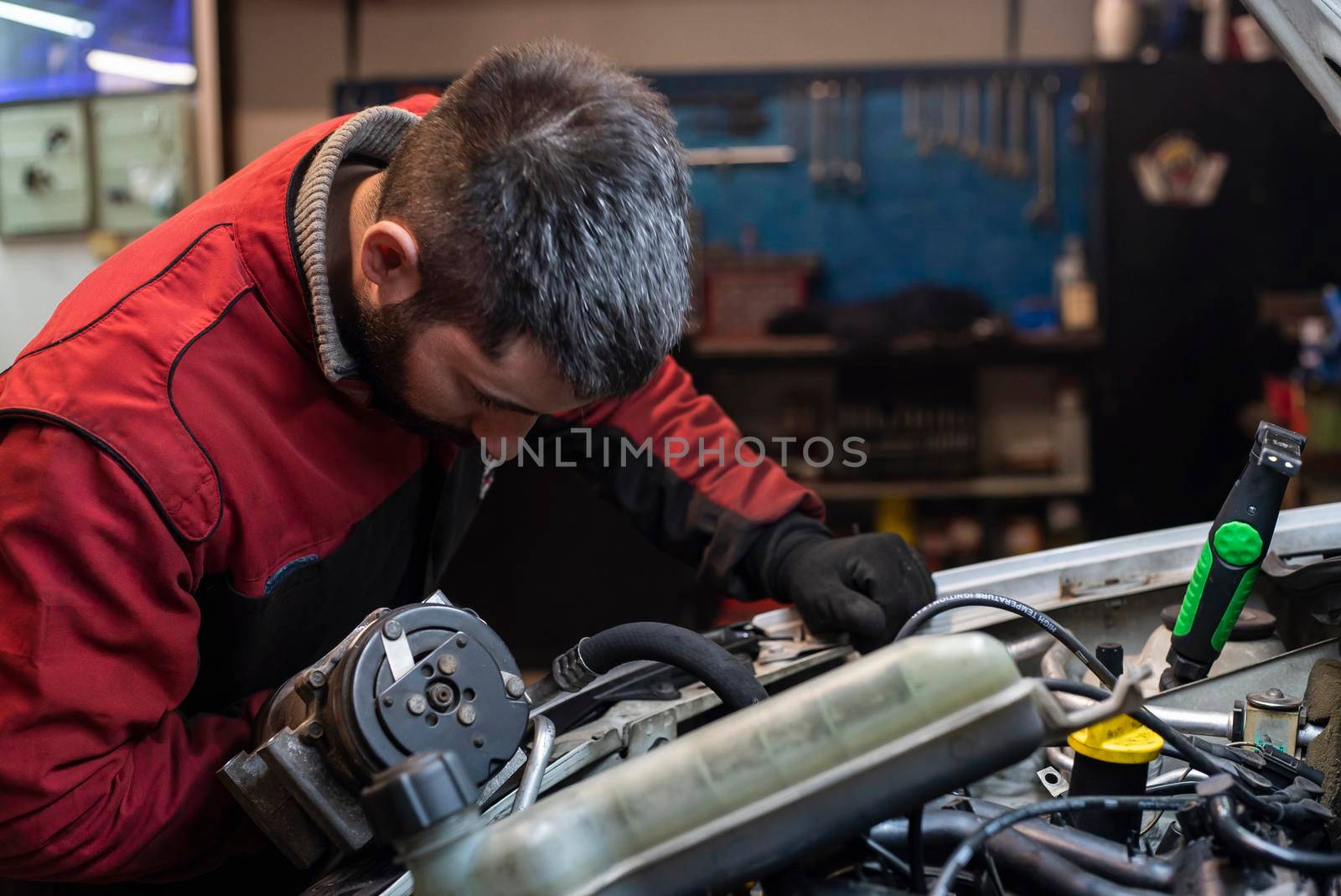 Mechanic working on the engine in the workshop