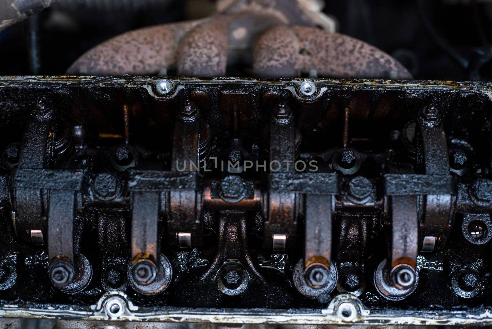 Dirty Valves and engine camshaft inside a broken engine