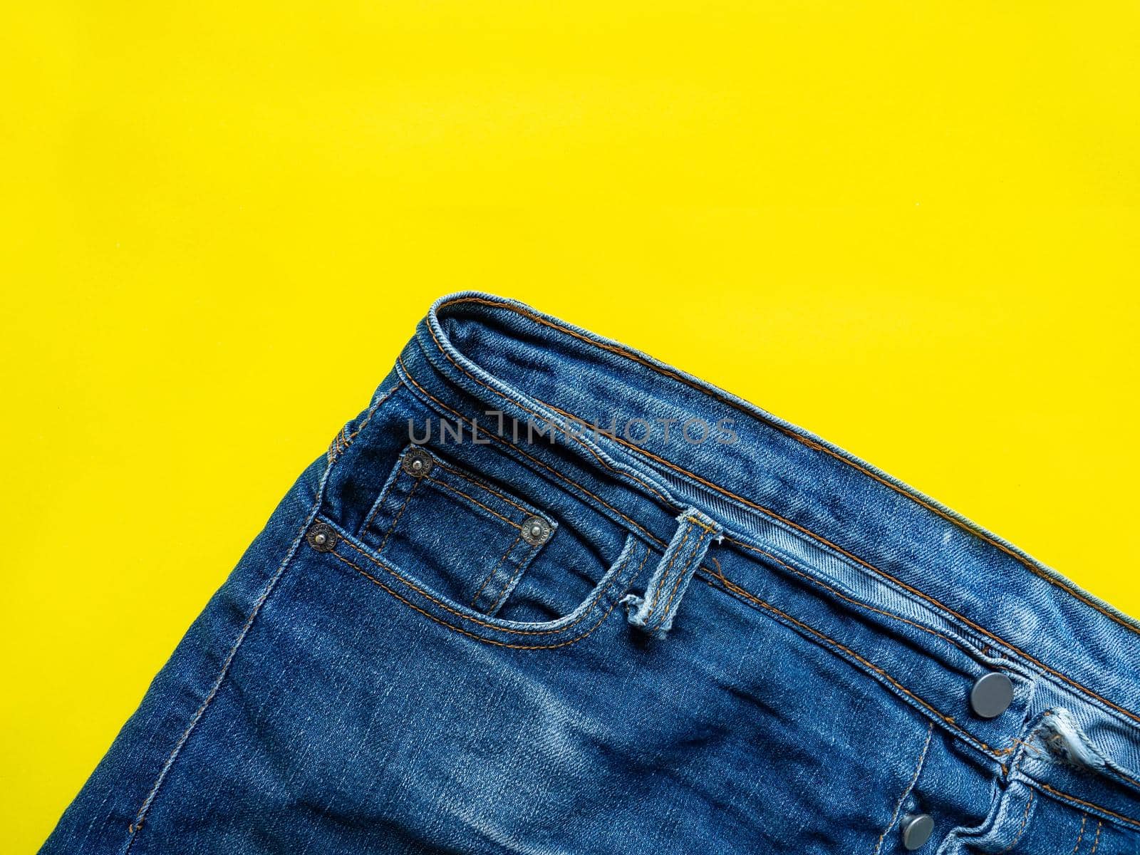 Blue pants Saw the fine pattern of the fabric Put on a yellow background