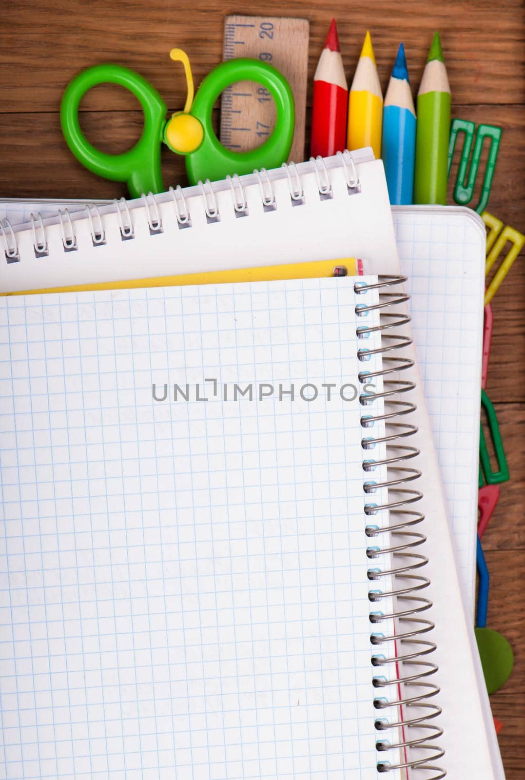 office supply and blank notepad on wooden table by aprilphoto