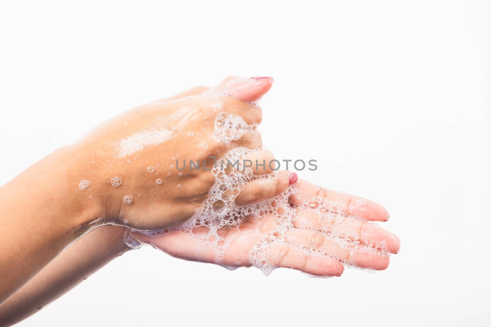 Woman washing hands by soap for cleanliness by Sorapop