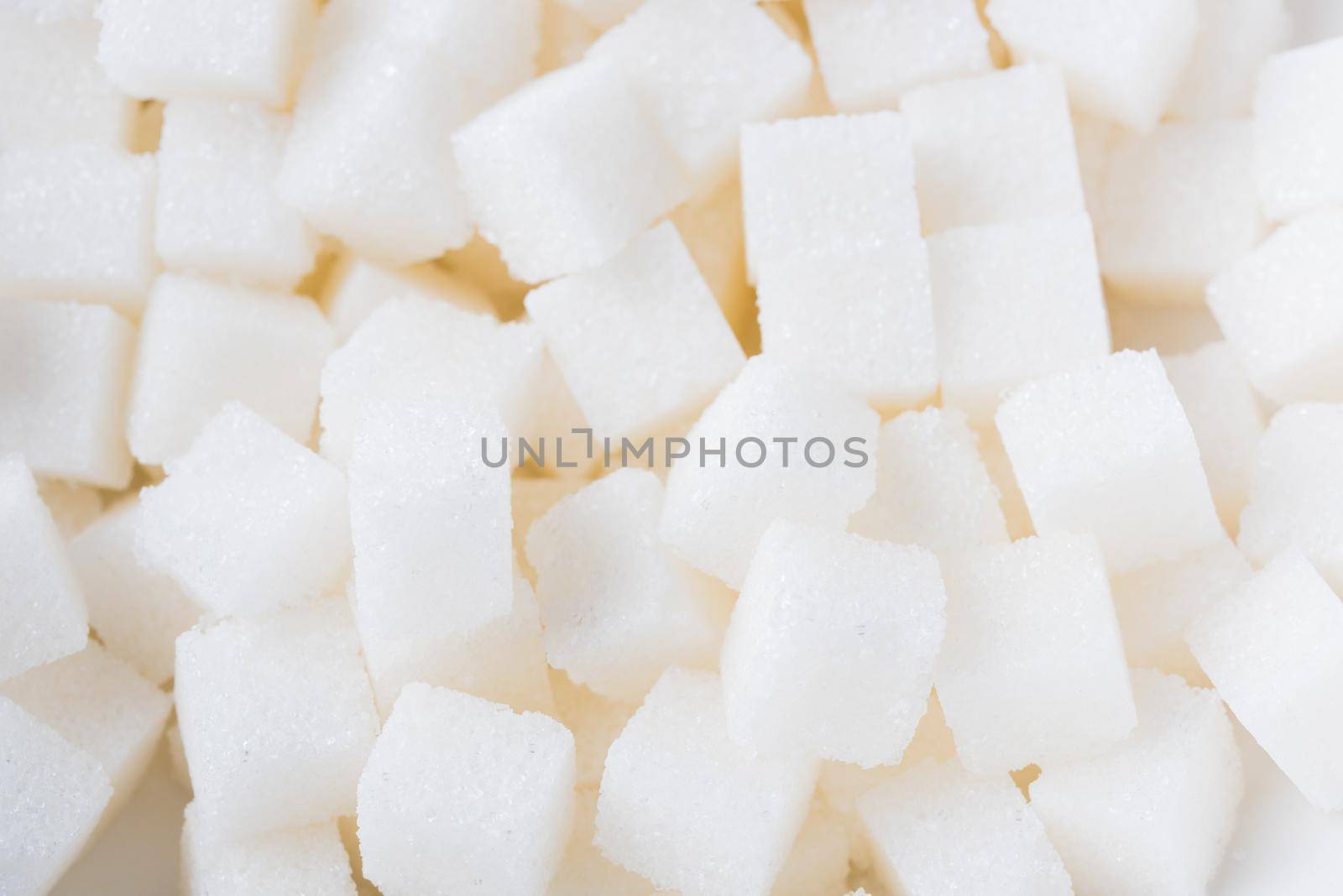 Sugar cube texture background sweet food ingredient, studio shot health high blood risk of diabetes, and calorie intake concept