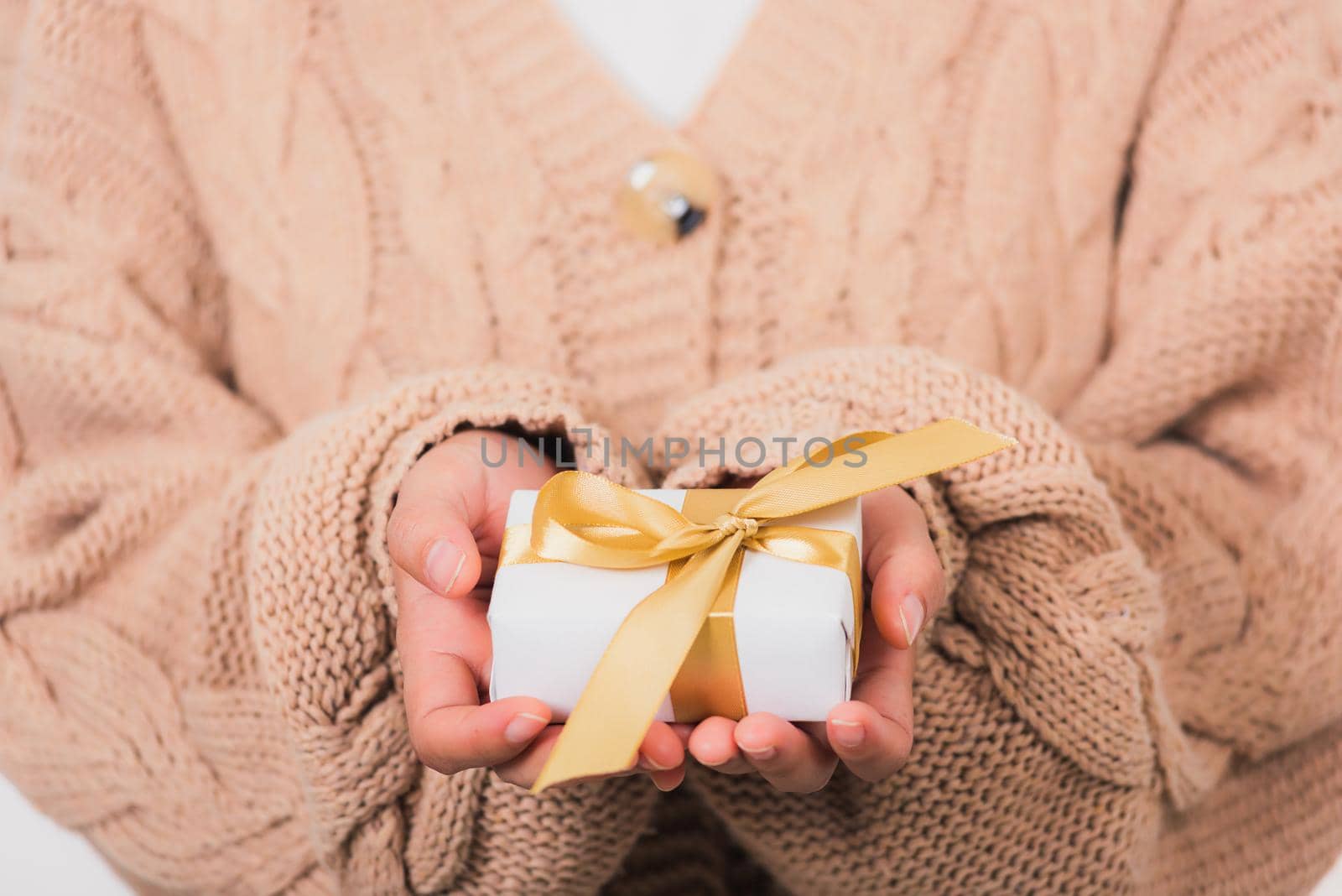 Valentine Day. Woman beauty hands holding small gift package box present wrapped paper with ribbon, Christmas, New year, Birthday holiday background concept