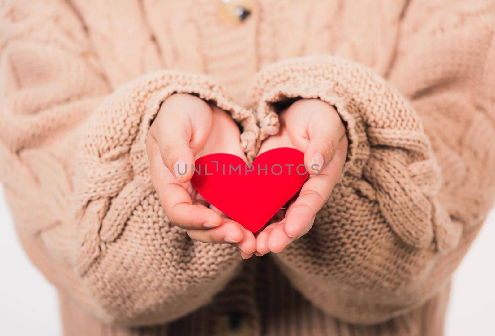 Love Valentine's Day. Female beauty hands holding modern a red heart isolated on white background, giving help donation medical healthcare happy holiday background concept