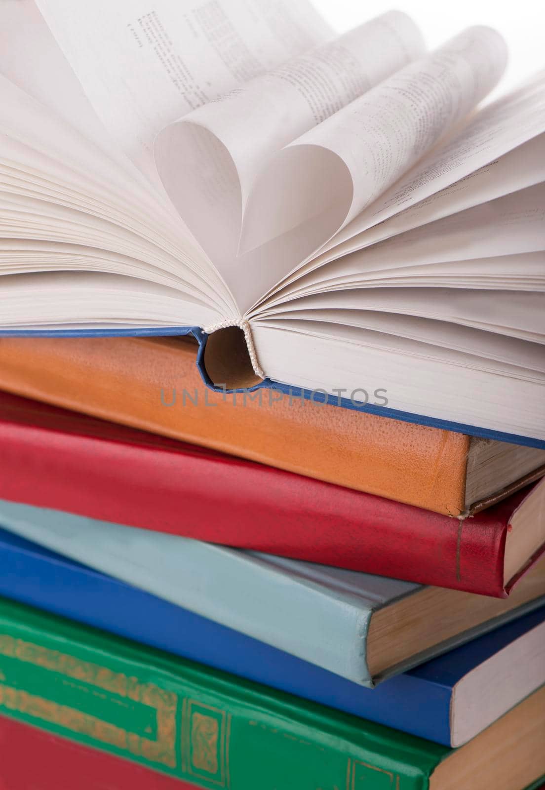 The book opens, and the book page rolls into the heart selective focus and with a very shallow depth of field by aprilphoto