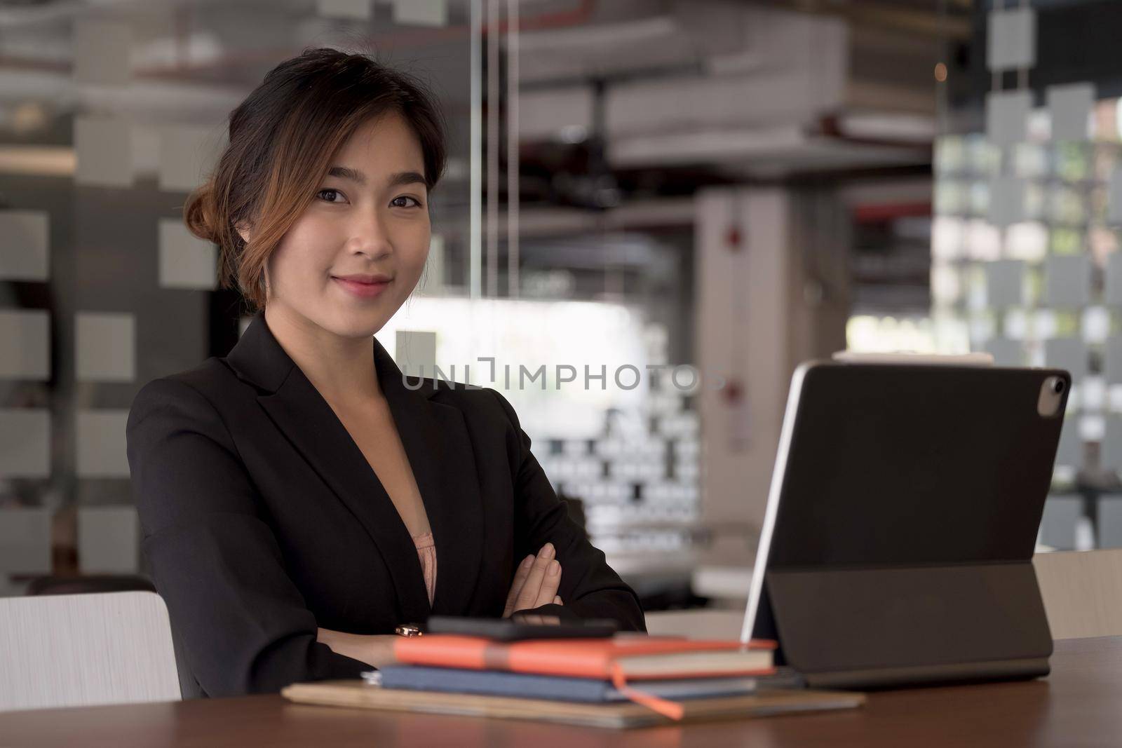 Young Asian Woman Working with Digital Tablet At Her Office. Business Financial Concept.