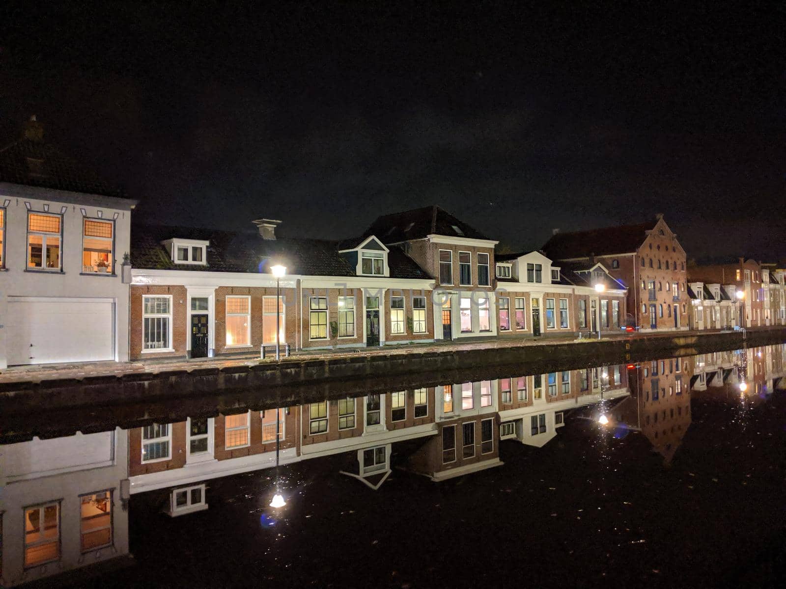 Housing along the canal at night in Sneek, Friesland, The Netherlands