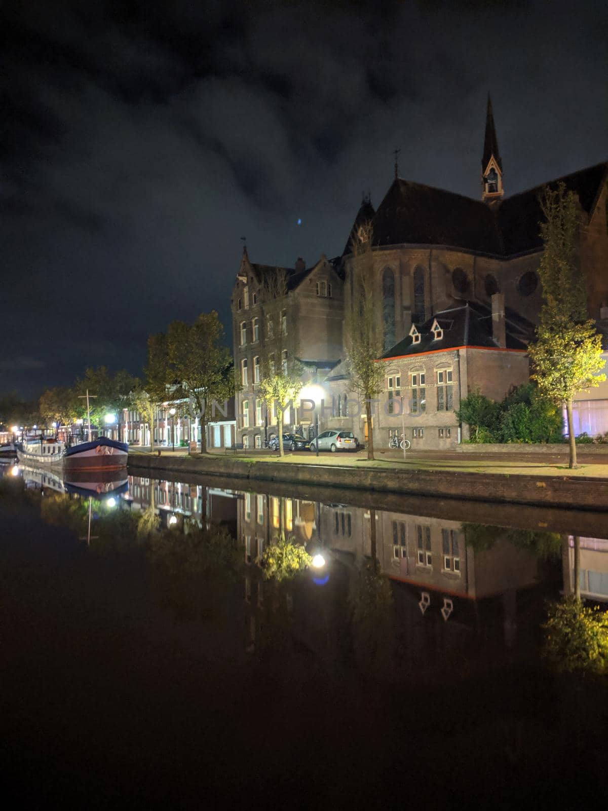 Church along the canal at night in Sneek, Friesland, The Netherlands