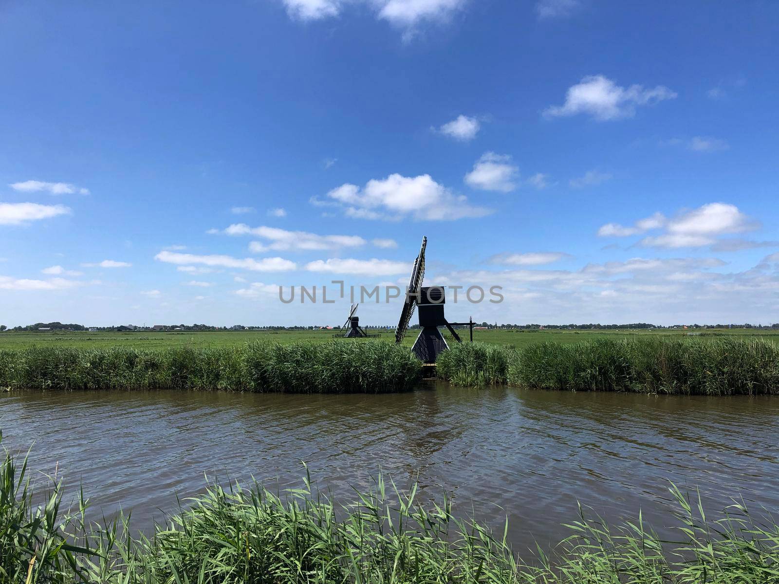 Windmills in Friesland The Netherlands by traveltelly