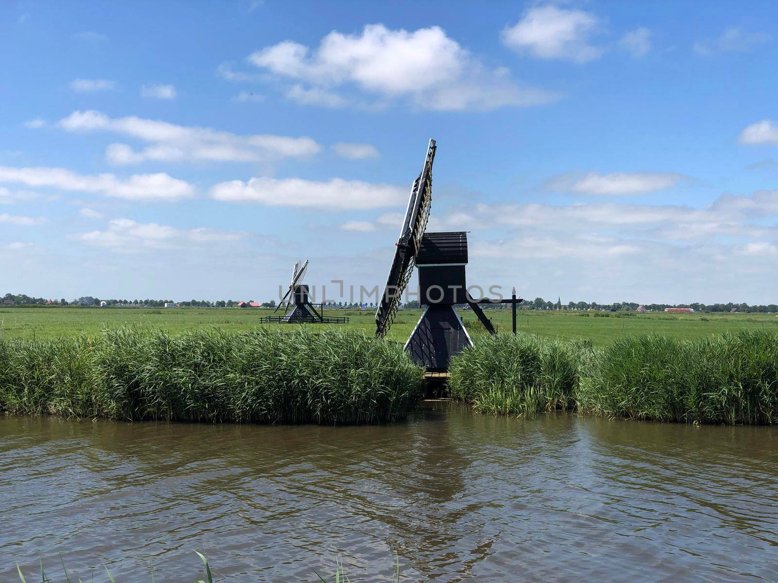 Windmills in Friesland The Netherlands by traveltelly