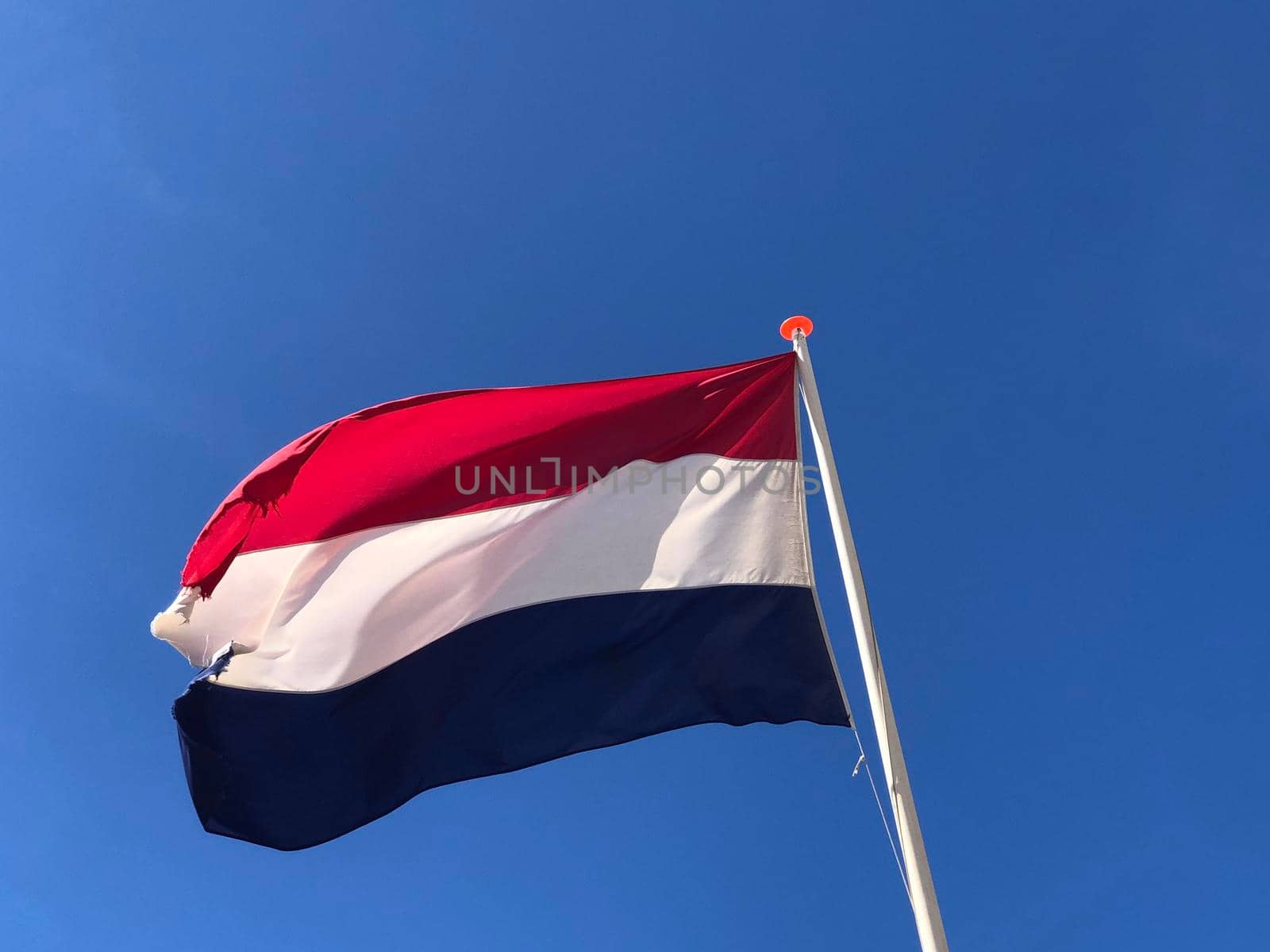 Dutch flag in Scheveningen by traveltelly