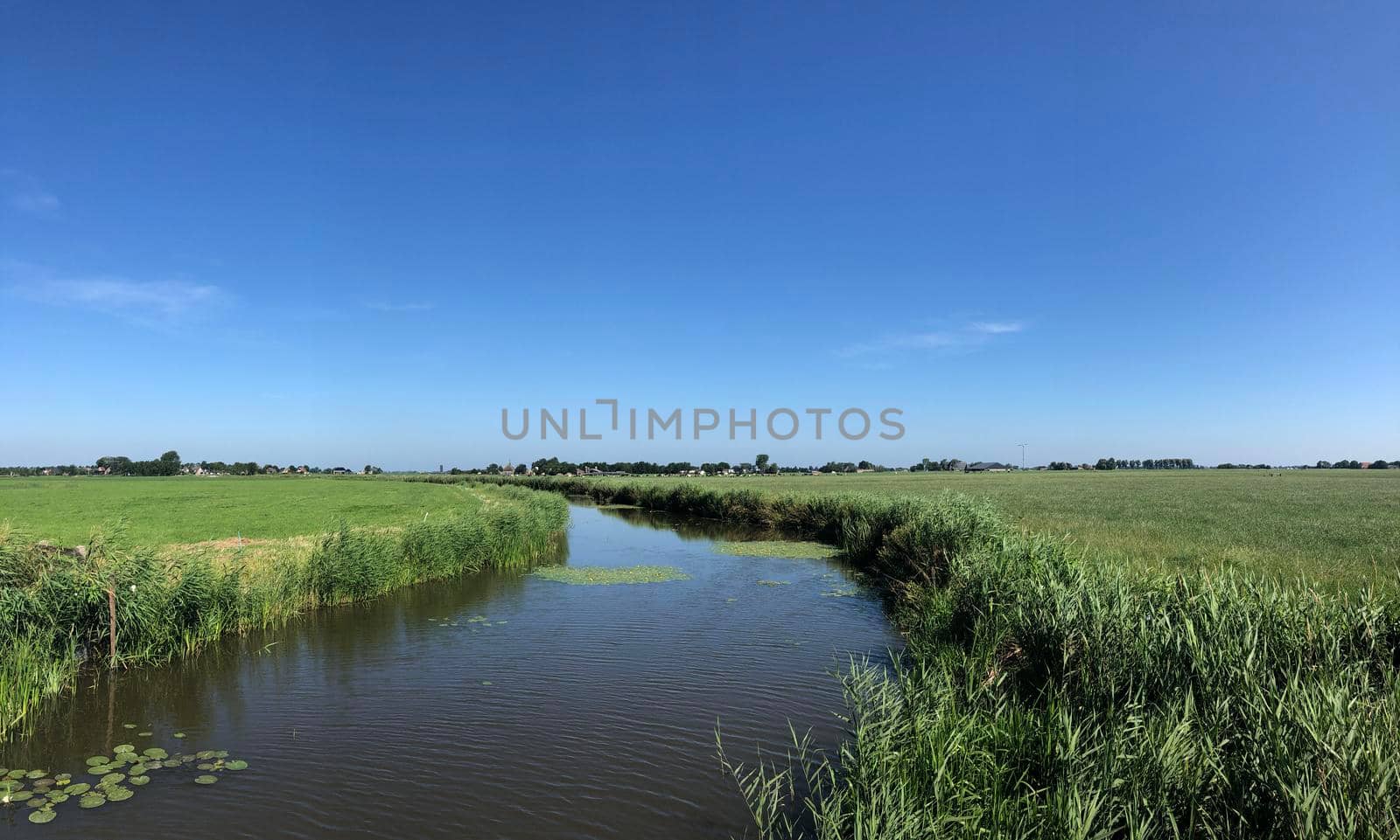 Canal around Bornwird in Friesland by traveltelly