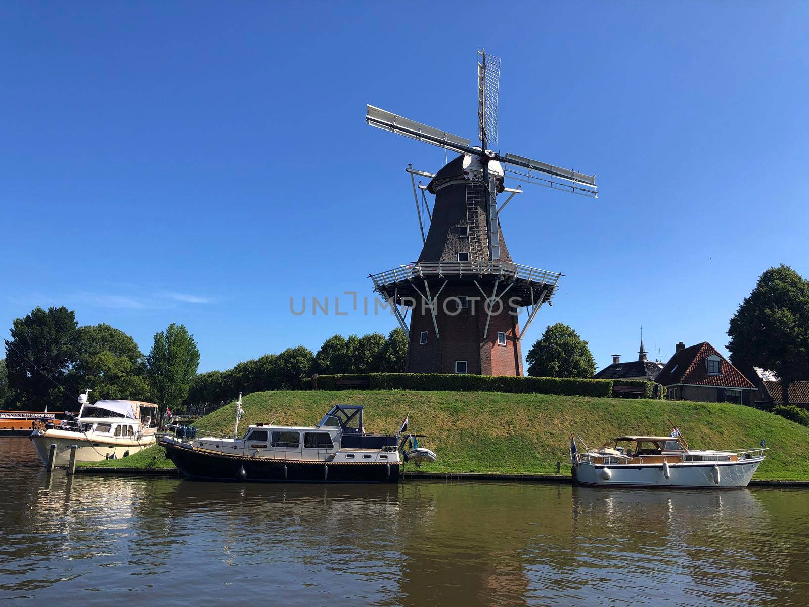 Windmill next to a canal in Dokkum, Friesland The Netherlands