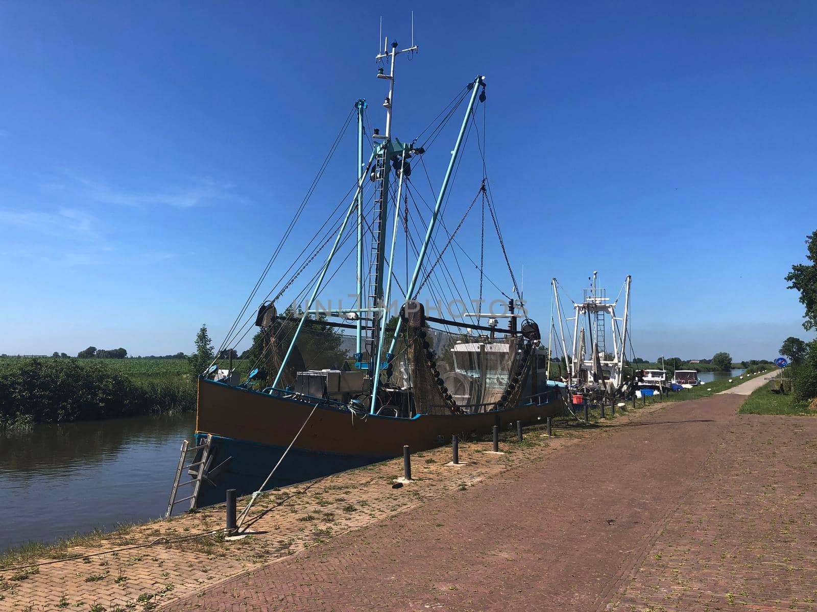 Fishing boats at a canal around Engwierum, Friesland, The Netherlands
