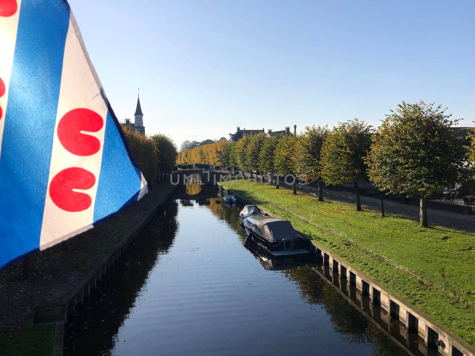 Frisian flag during autumn in Sloten by traveltelly