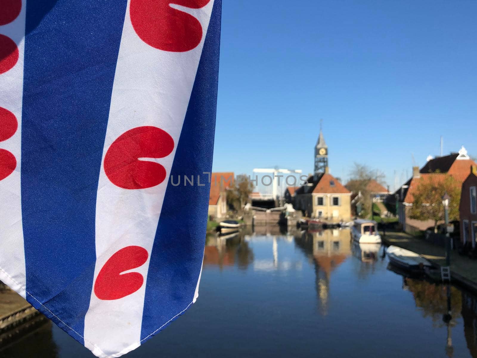 Frisian flag at a canal in Hindeloopen  by traveltelly