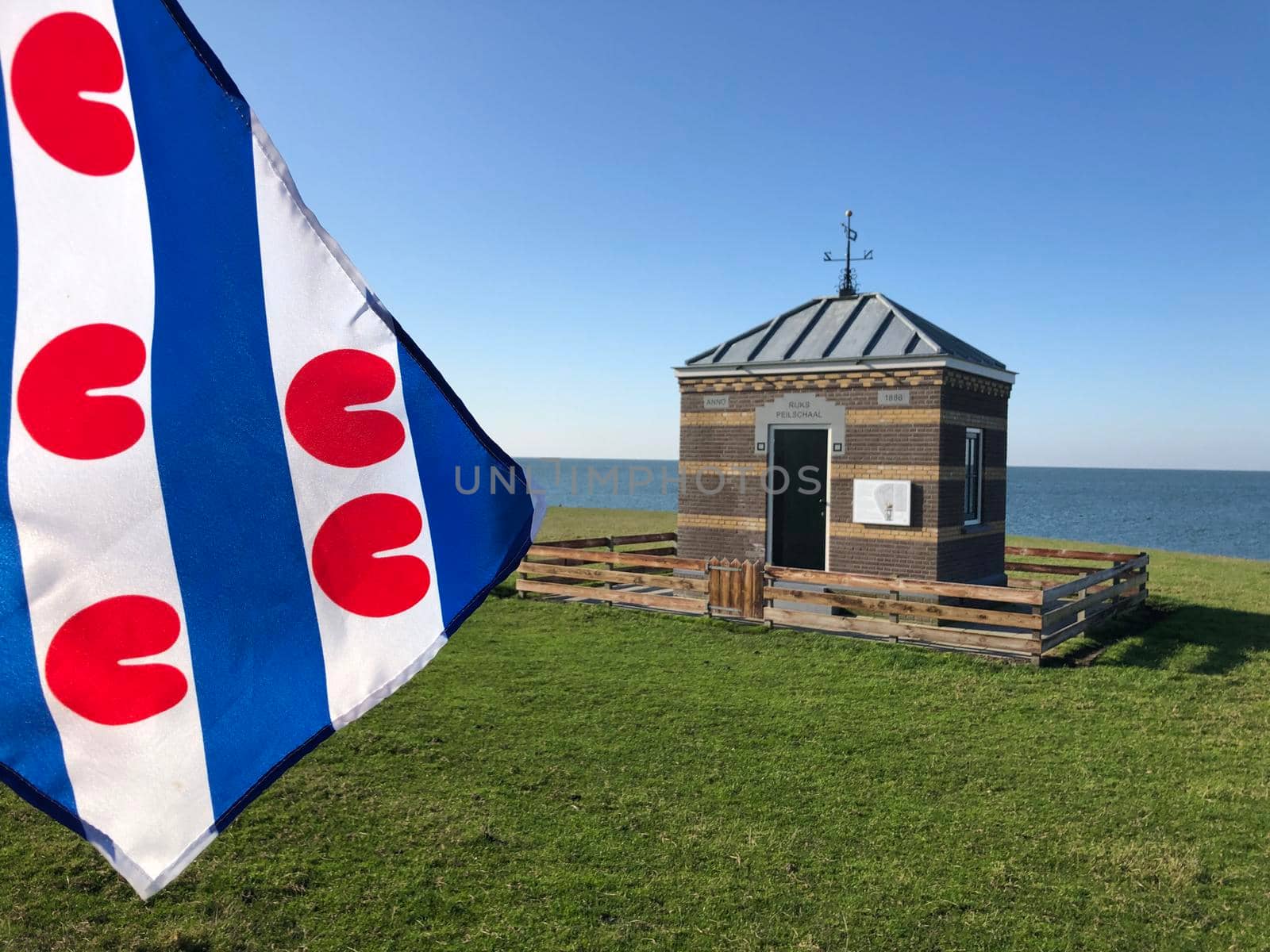 Frisian flag at the Rijks Peilschaal house in Hindeloopen, Friesland The Netherlands