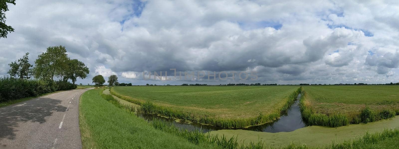 Cloudy Frisian panoramic landscape in The Netherlands