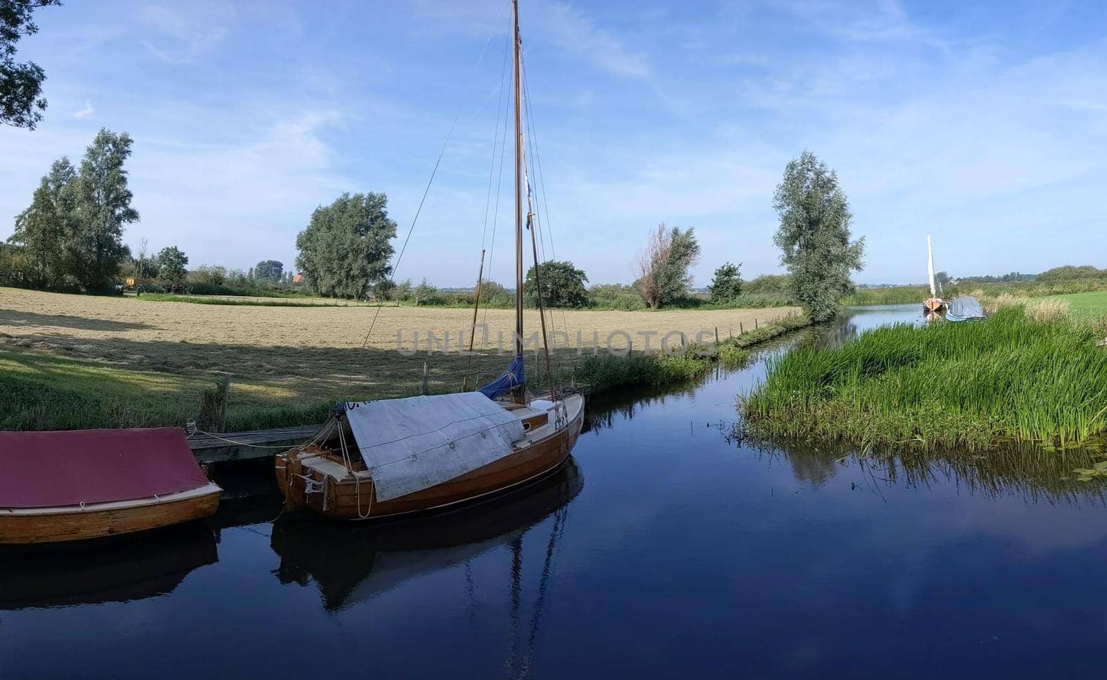 Sailboats in a canal around Langelille by traveltelly