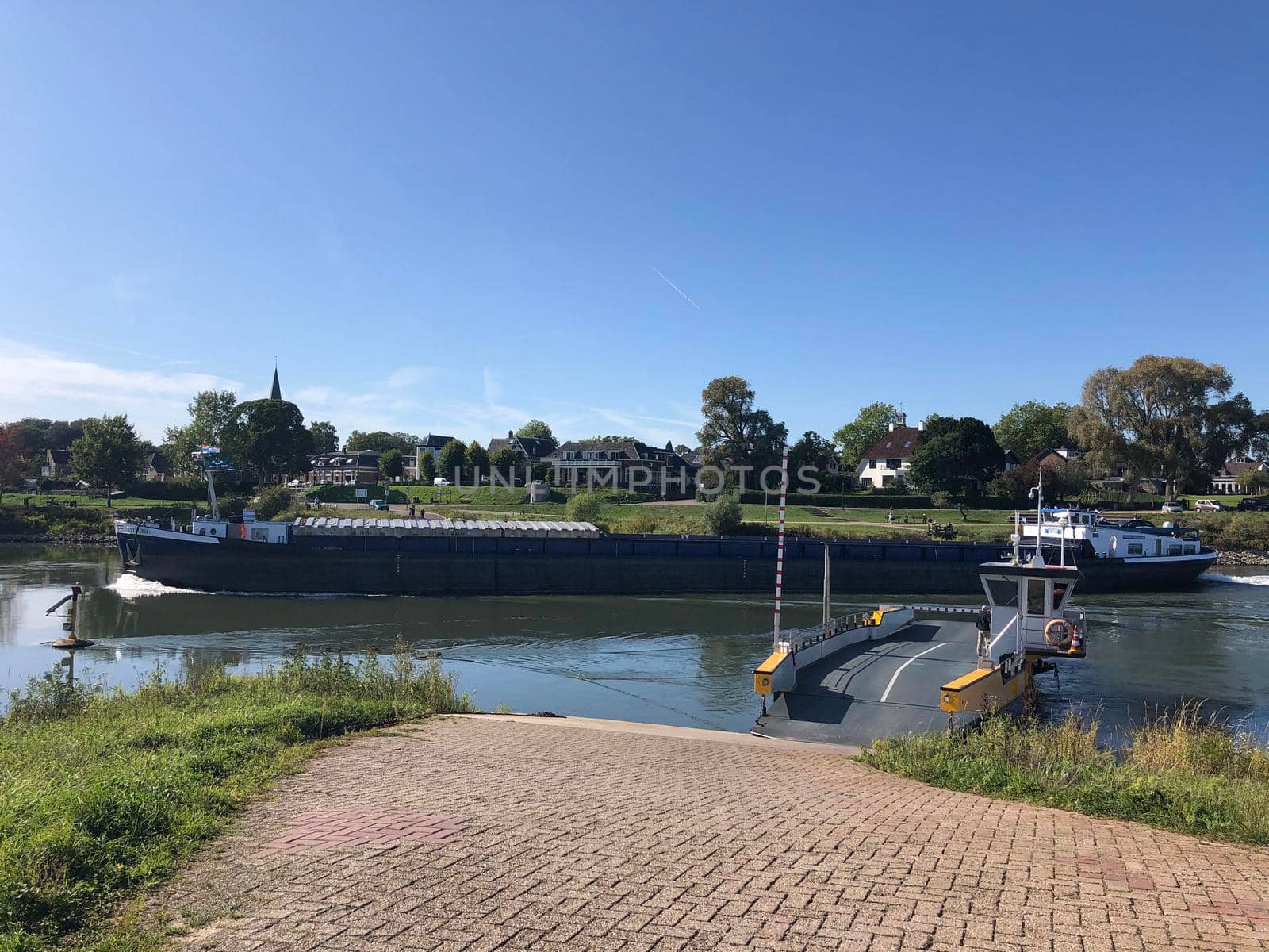 Ferry and cargo ship at the IJssel river between Olburgen and Dieren by traveltelly