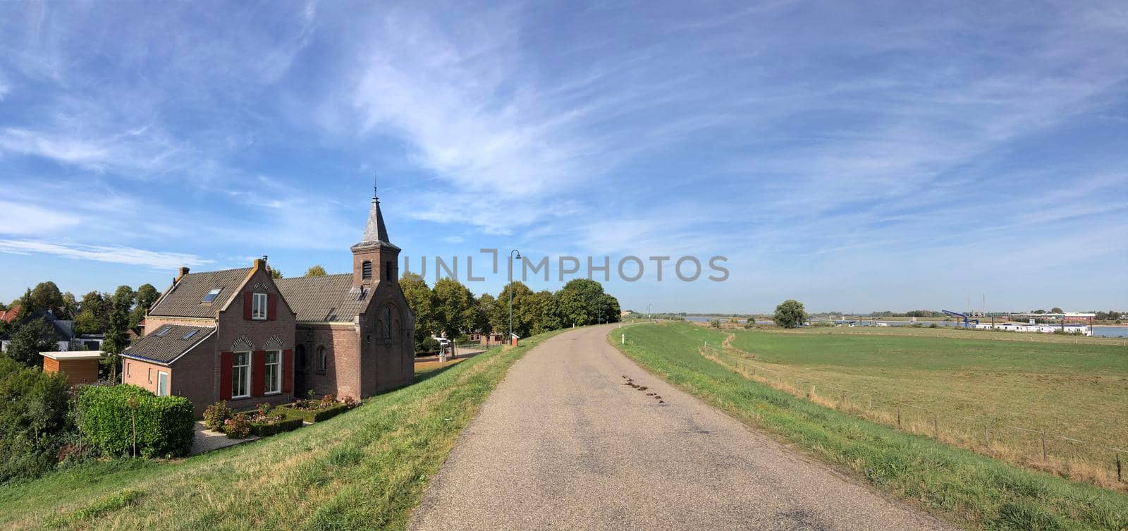 Small church behind the dyke  by traveltelly