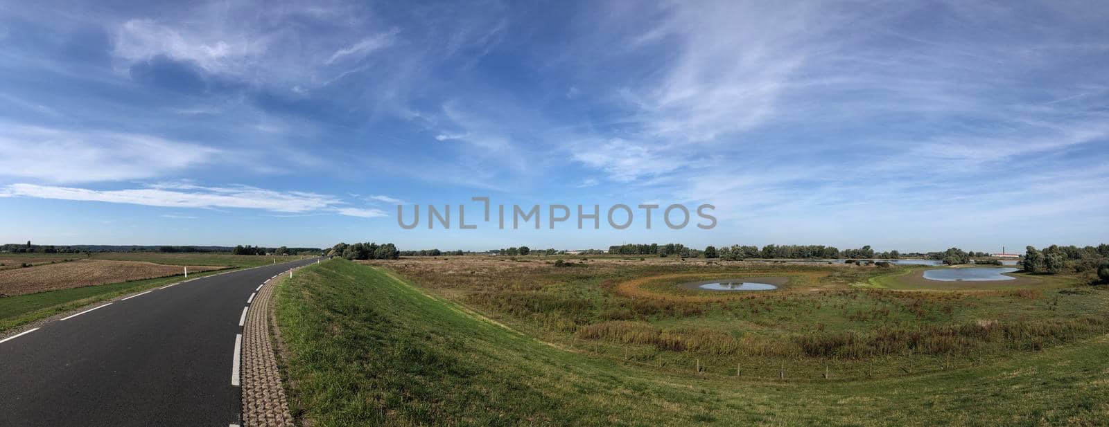 Road on a dyke around Leuth in Gelderland  by traveltelly