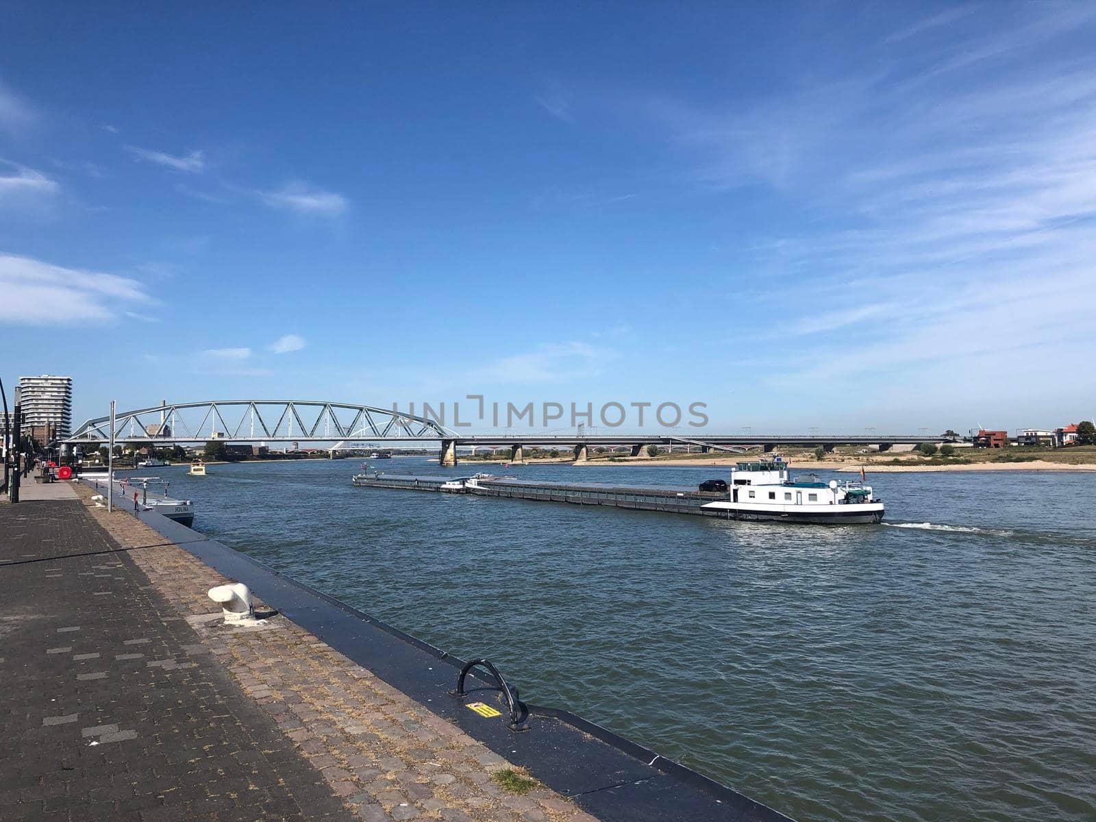 Cargo ship on the Waal river in Nijmegen by traveltelly