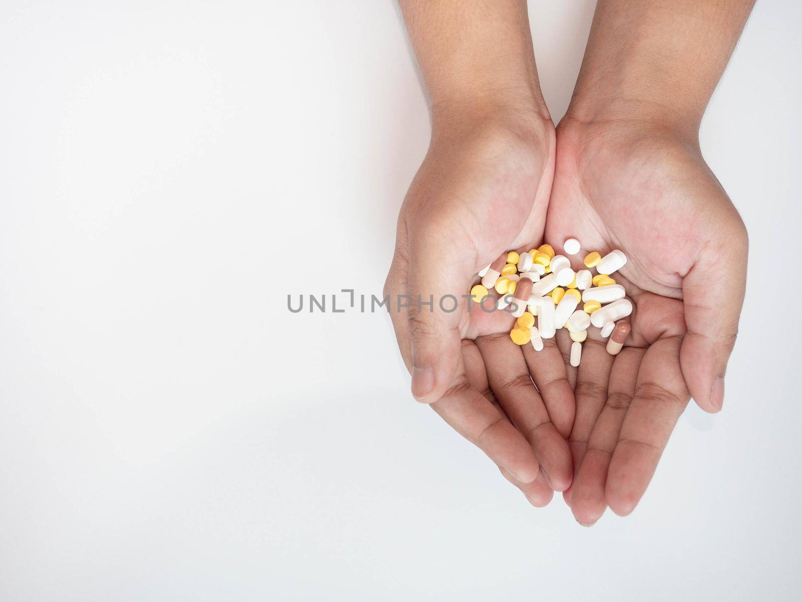 Colorful pills on hand On a white background by Kulpreya