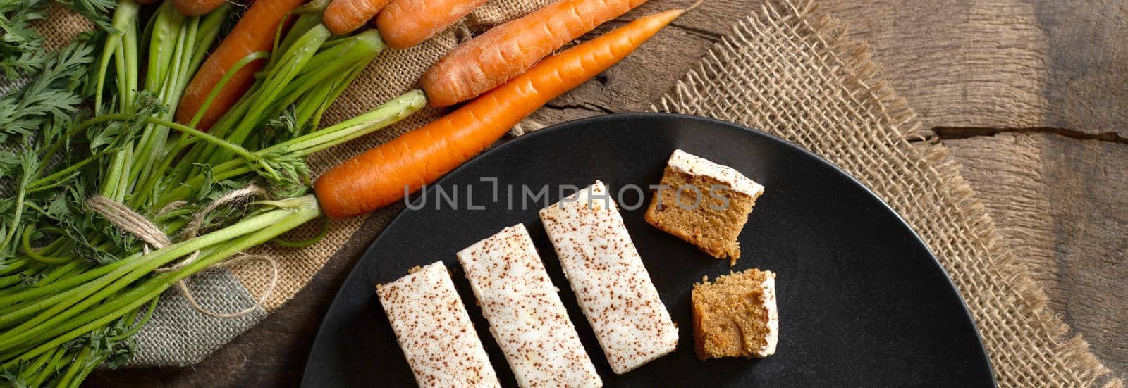 Fresh bunch of carrots on old wood background. by NelliPolk