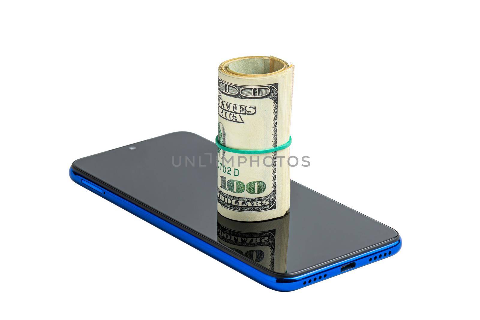 Money in a roll, tied with an elastic band, on the phone. The isolated object on a white background. U.S. dollars. Phone and dollars isolated on white.