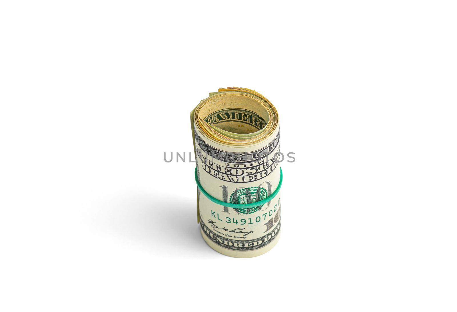 Money on a roll tied with an elastic band. The isolated object on a white background with a shadow. Close up photo of money. U.S. dollars. Banknotes. Paper money isolated on white background.