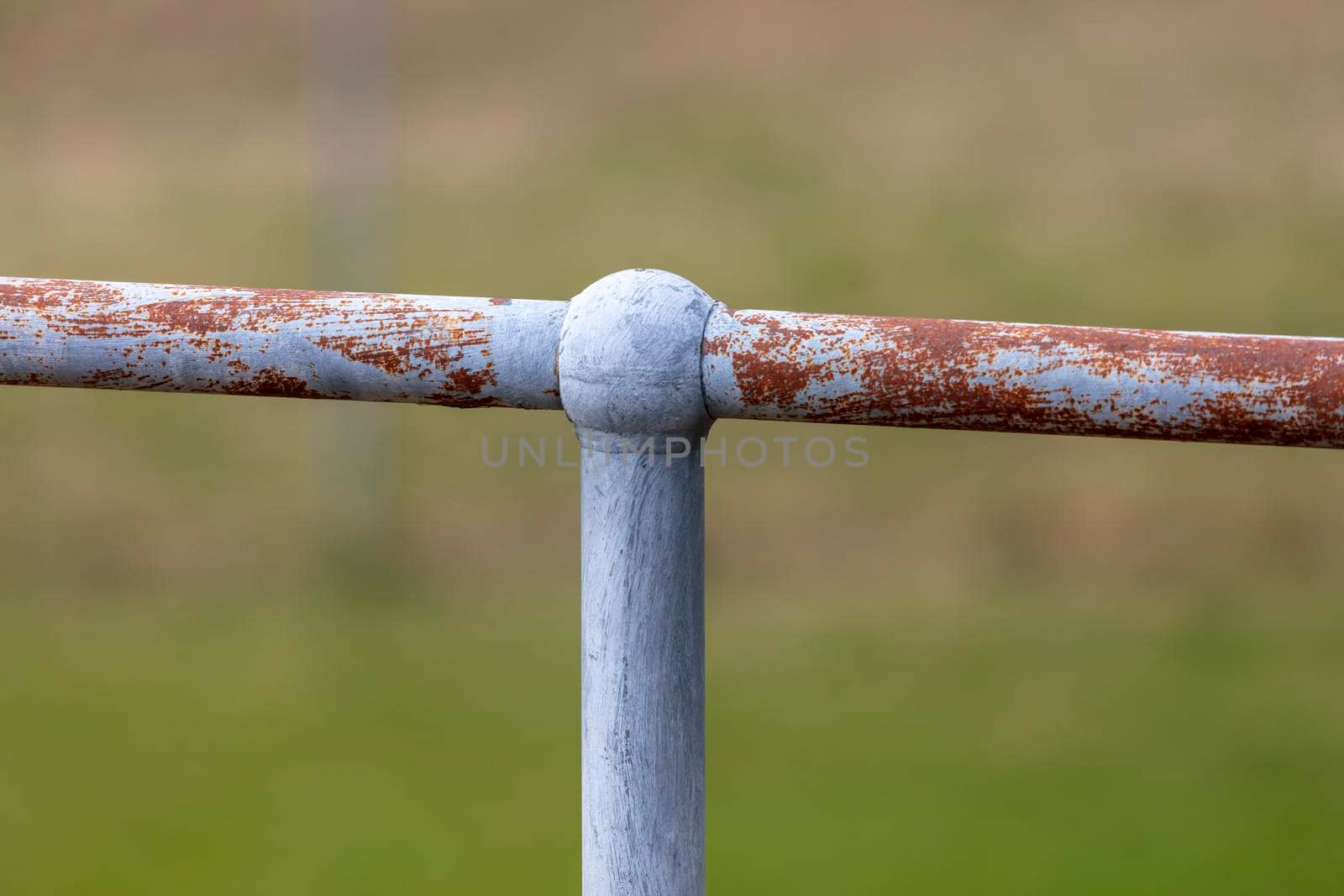 A rusty steel fence post and hand rail by WittkePhotos