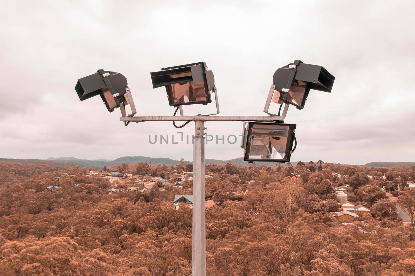 Aerial view of a 4 head sports field lighting structure on a white cloud background