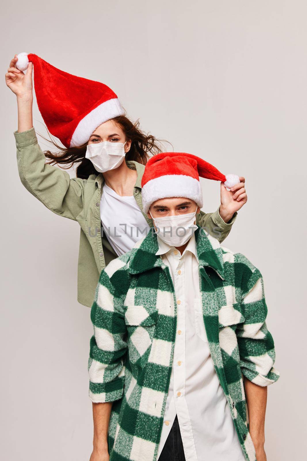 Christmas family holiday fun woman in santa hat and young man. High quality photo