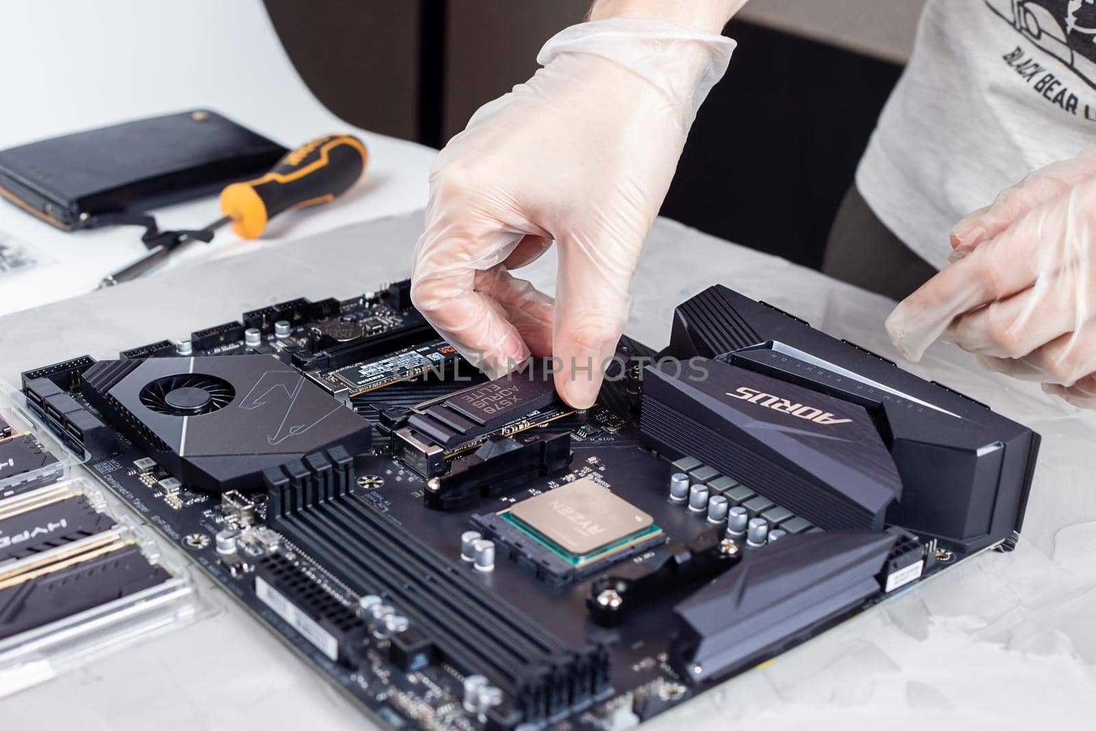 Moscow, Russia - 25 Dec 2020: Man installing heatsink on top of a m2 hard drive. by galinasharapova