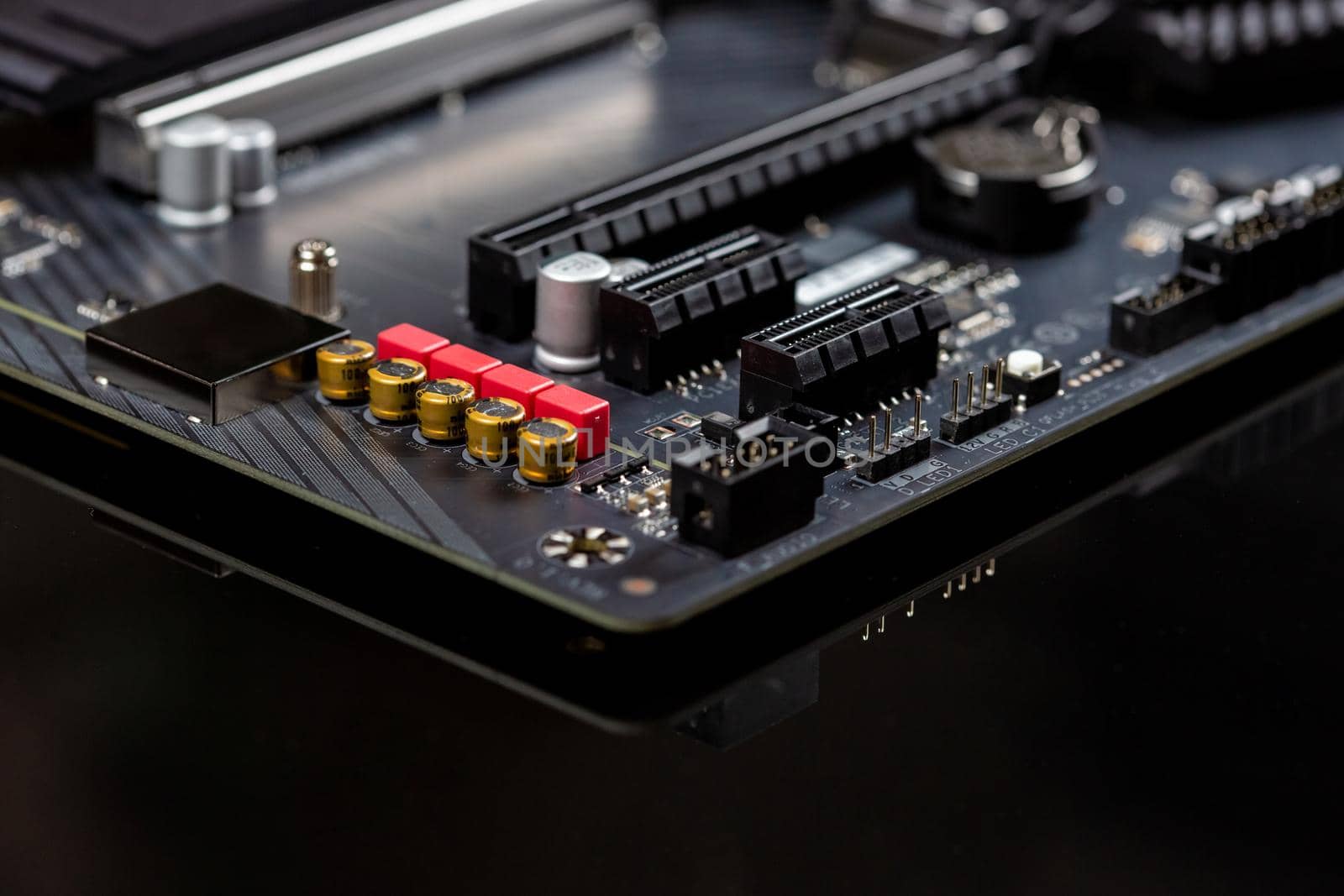 Motherboard on a table close-up, inside of a desktop computer showing chips, circuit boards and components