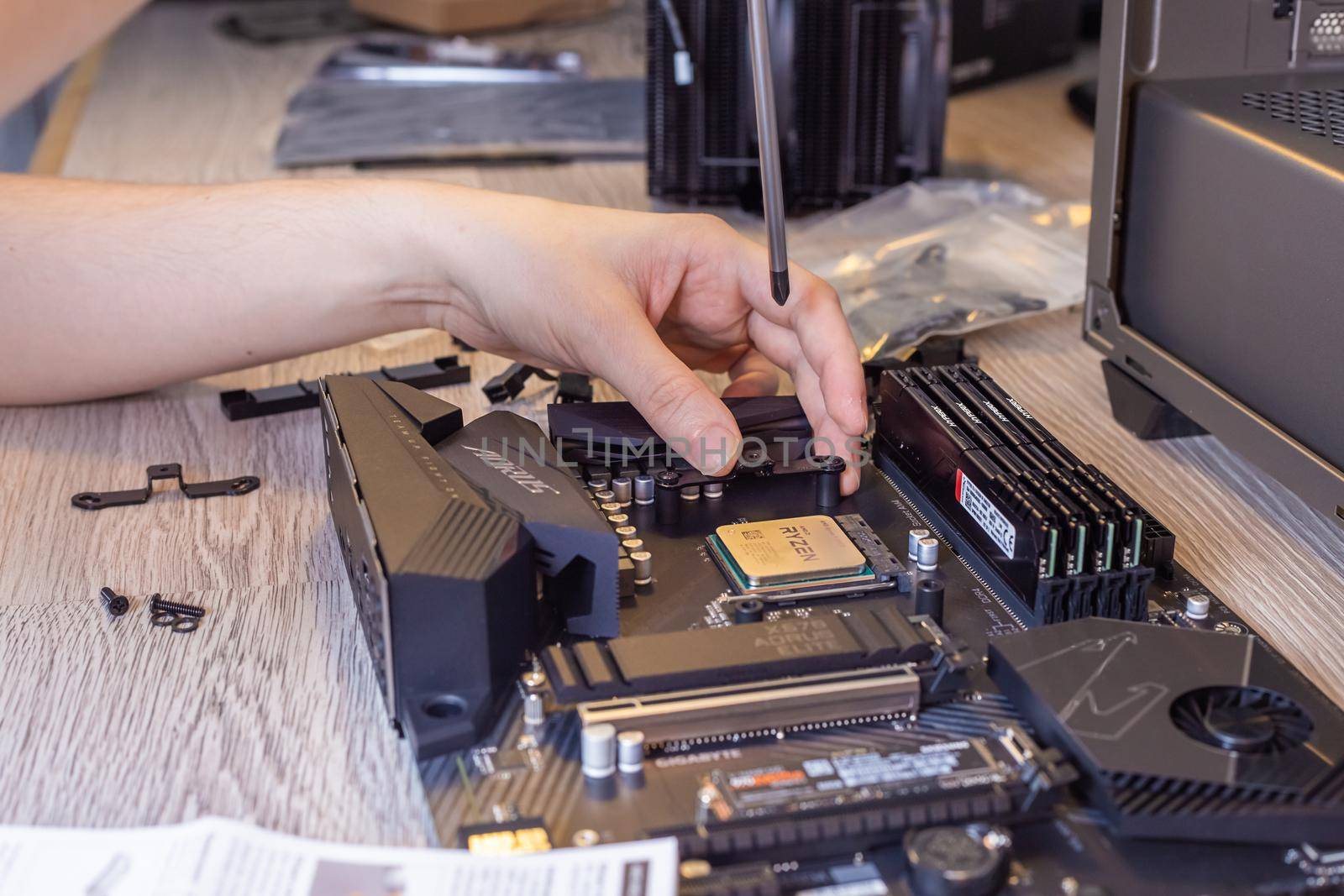 Moscow, Russia - 25 Dec 2020: Installing a processor fan on the computer motherboard, PC assembly