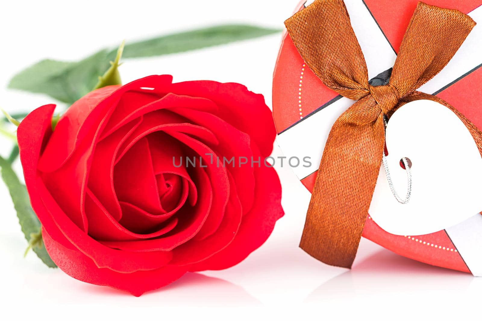 Close up red rose and heart shaped box on white  by stoonn