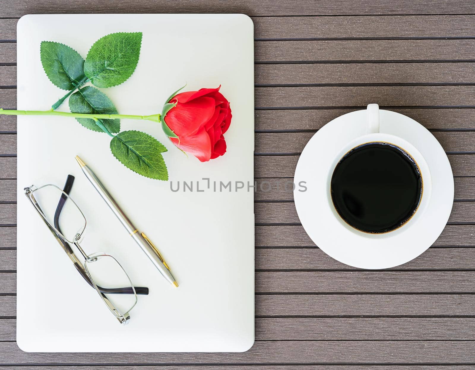 Top view coffee time with copy space valentine's day concept , Office desk table with laptop,notebook, coffee cup,red rose