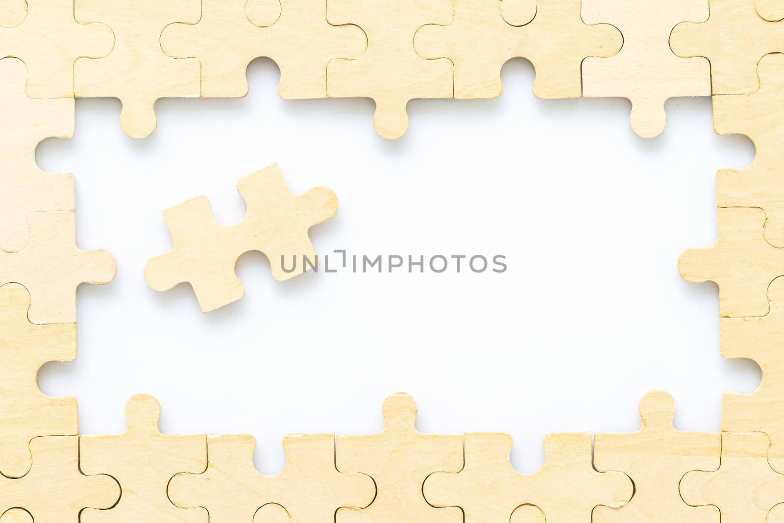 wooden jigsaw puzzle pieces on white background by stoonn