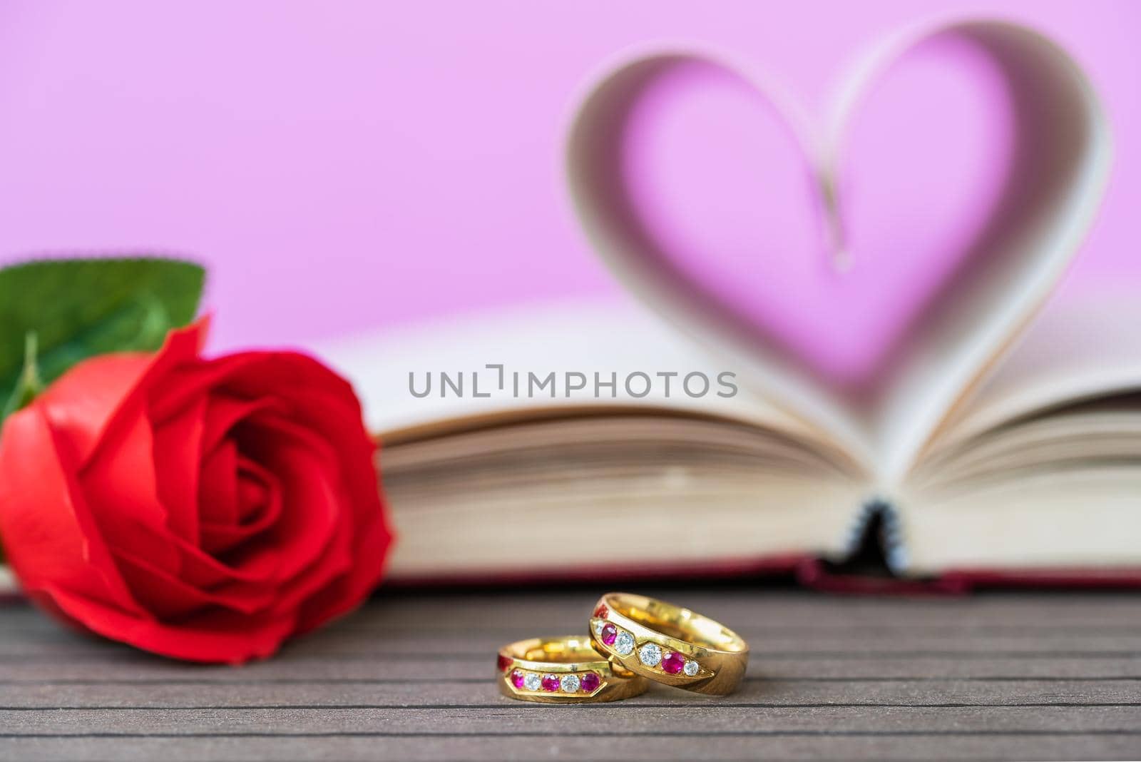 Pages of book curved  heart shape with wedding ring by stoonn