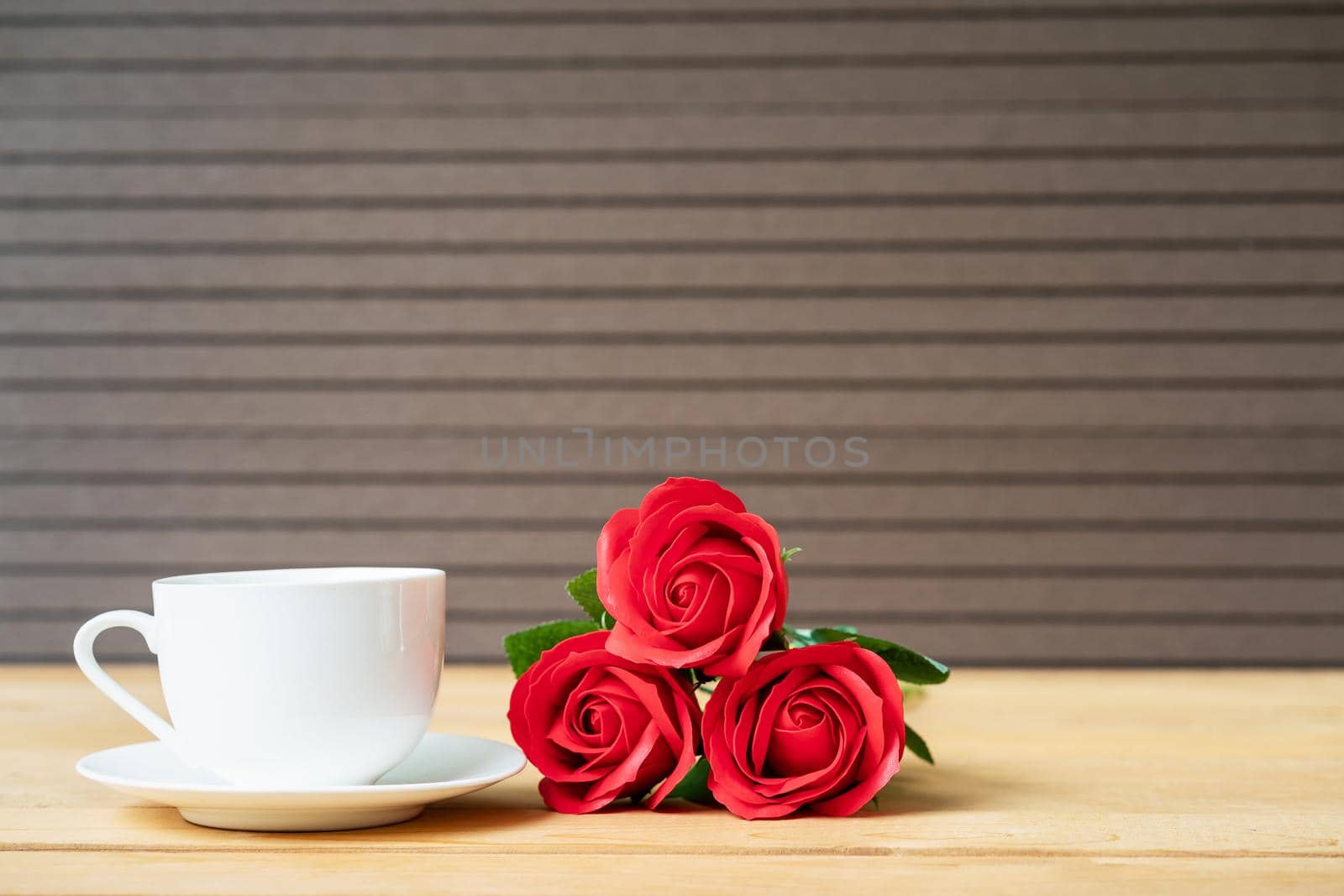 Red rose and coffee cup on wood  by stoonn