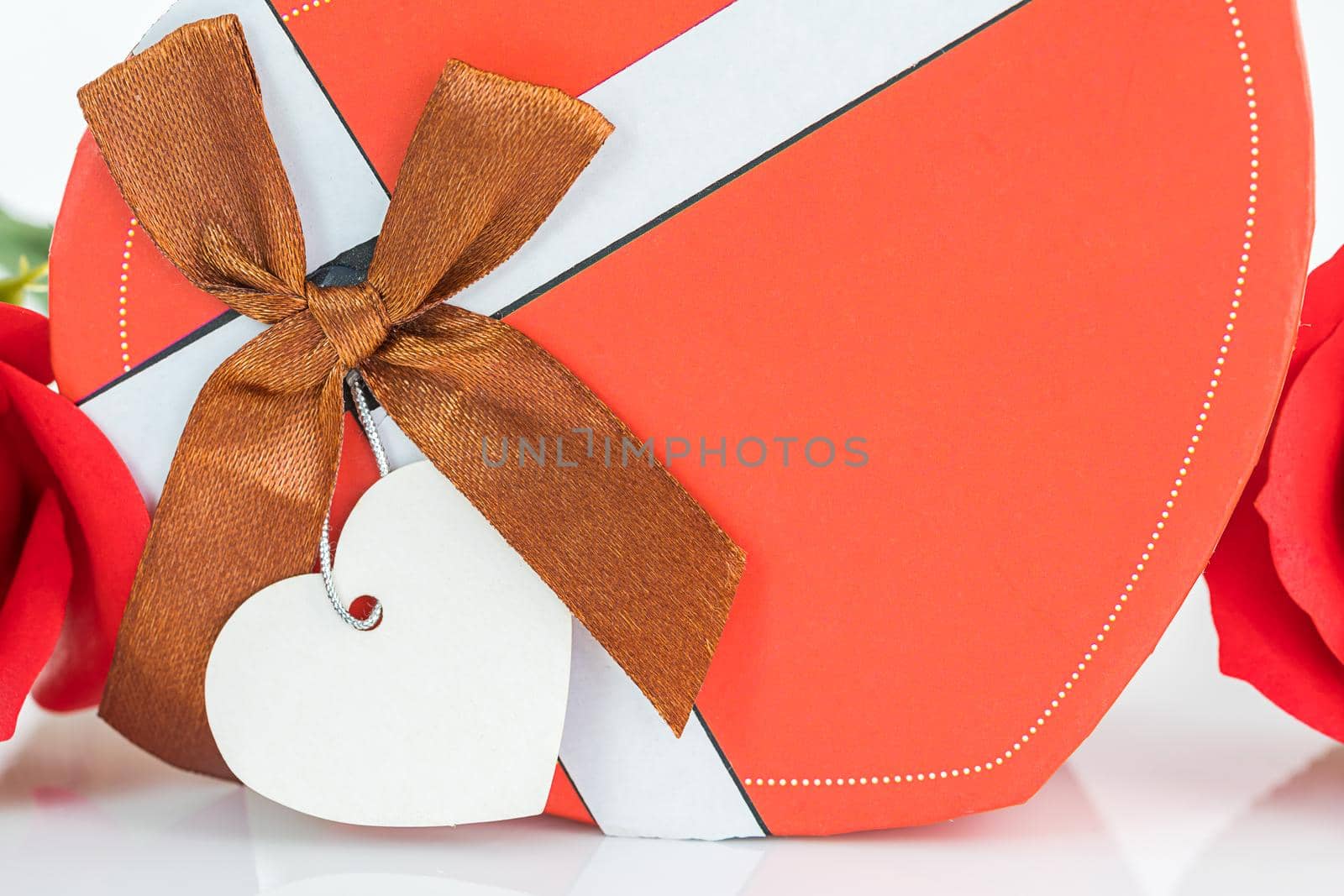 Close up red roses and heart-shaped box ,Valentine's Day concept with roses and red heart-shaped box