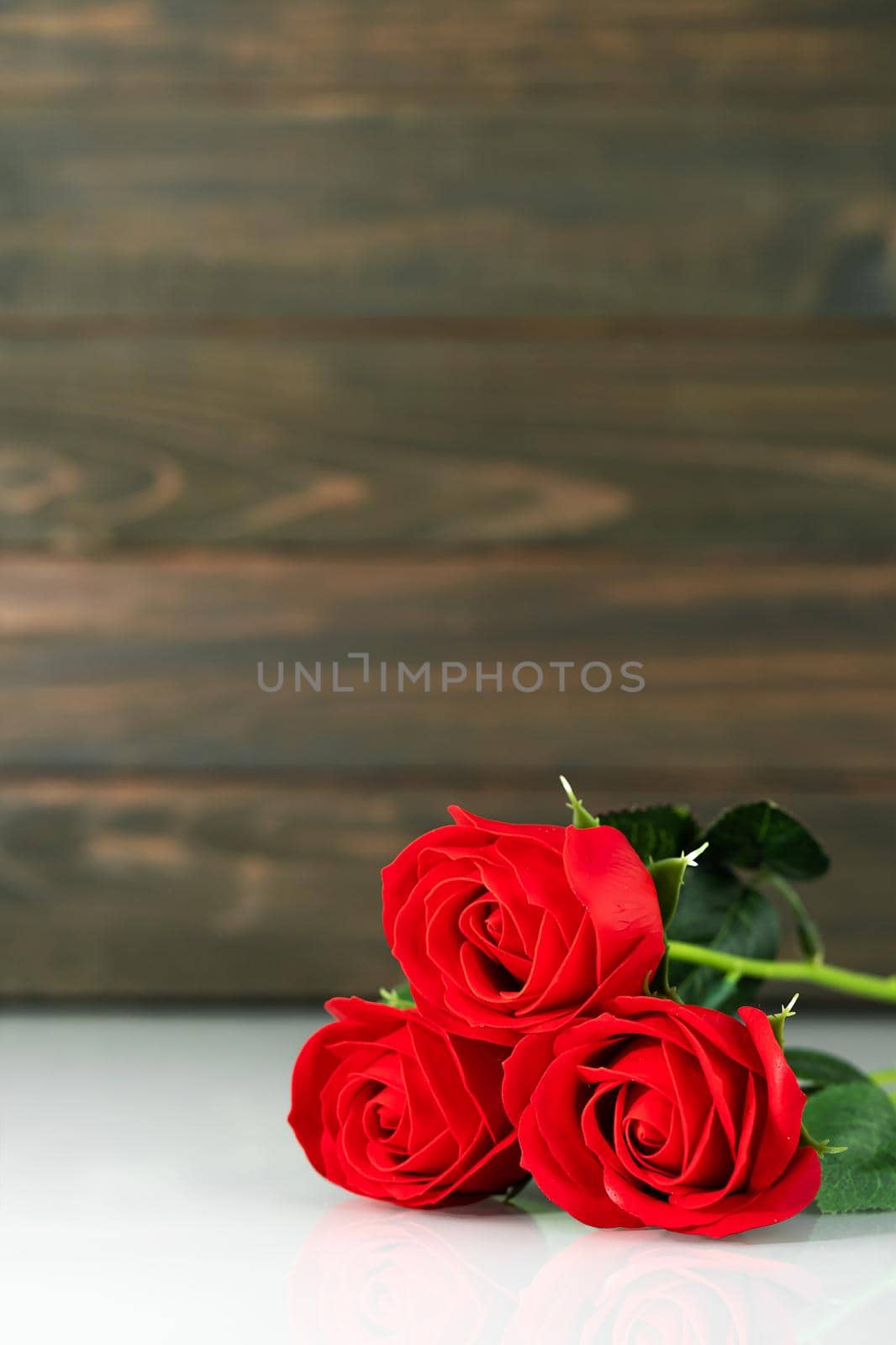 Red roses on table with copy space by stoonn