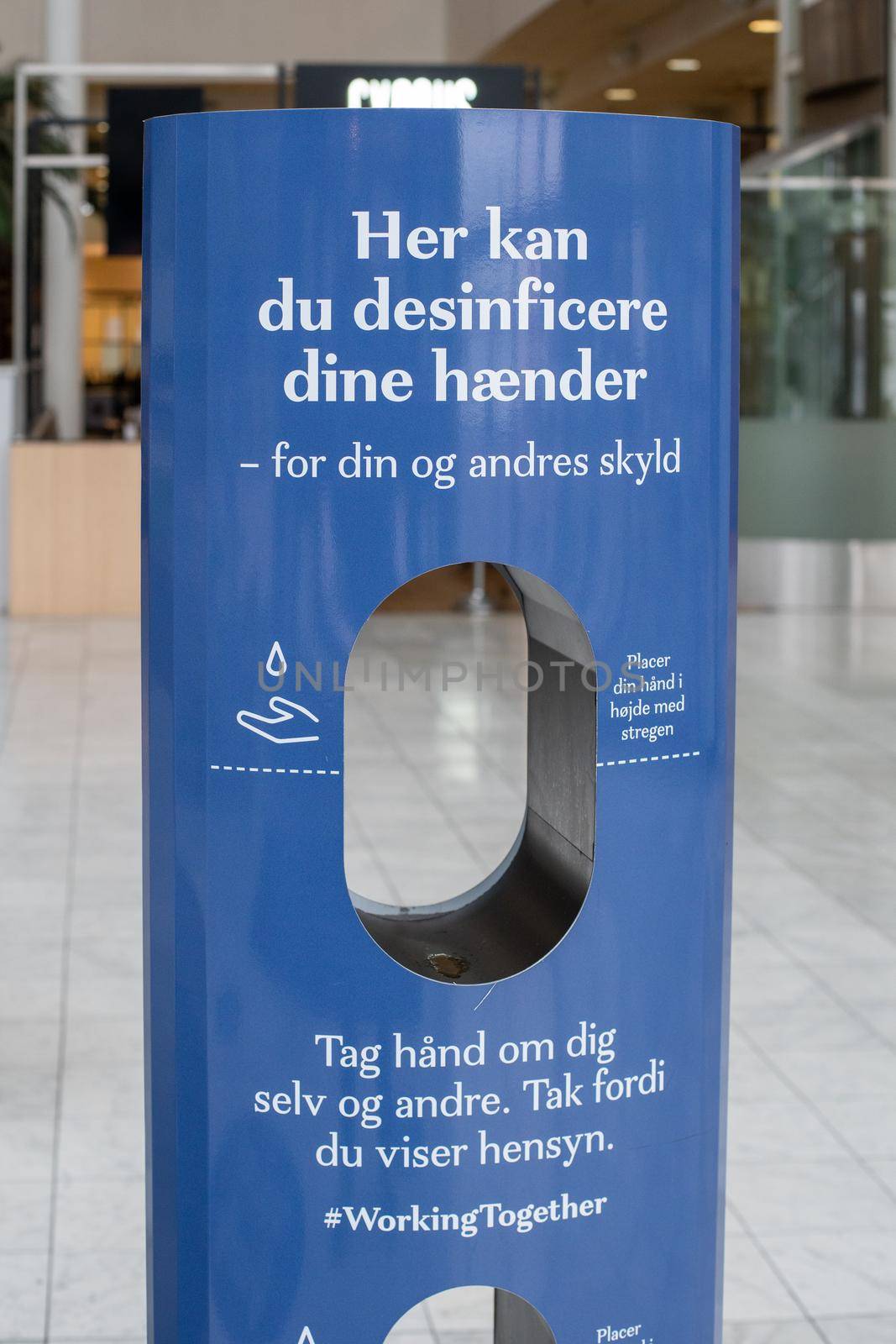 Copenhagen, Denmark - November 17, 2020: A hand sanitizer station inside Fisketorvet Shopping Mall.