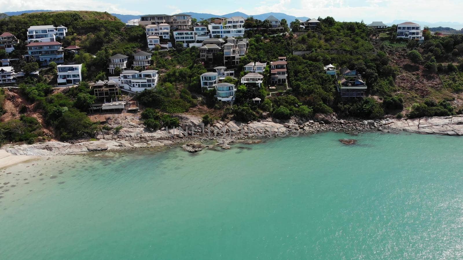 Green island with houses in ocean. Drone view of beautiful Ko Samui island in Thailand surrounded by turquoise water on sunny day. by DogoraSun