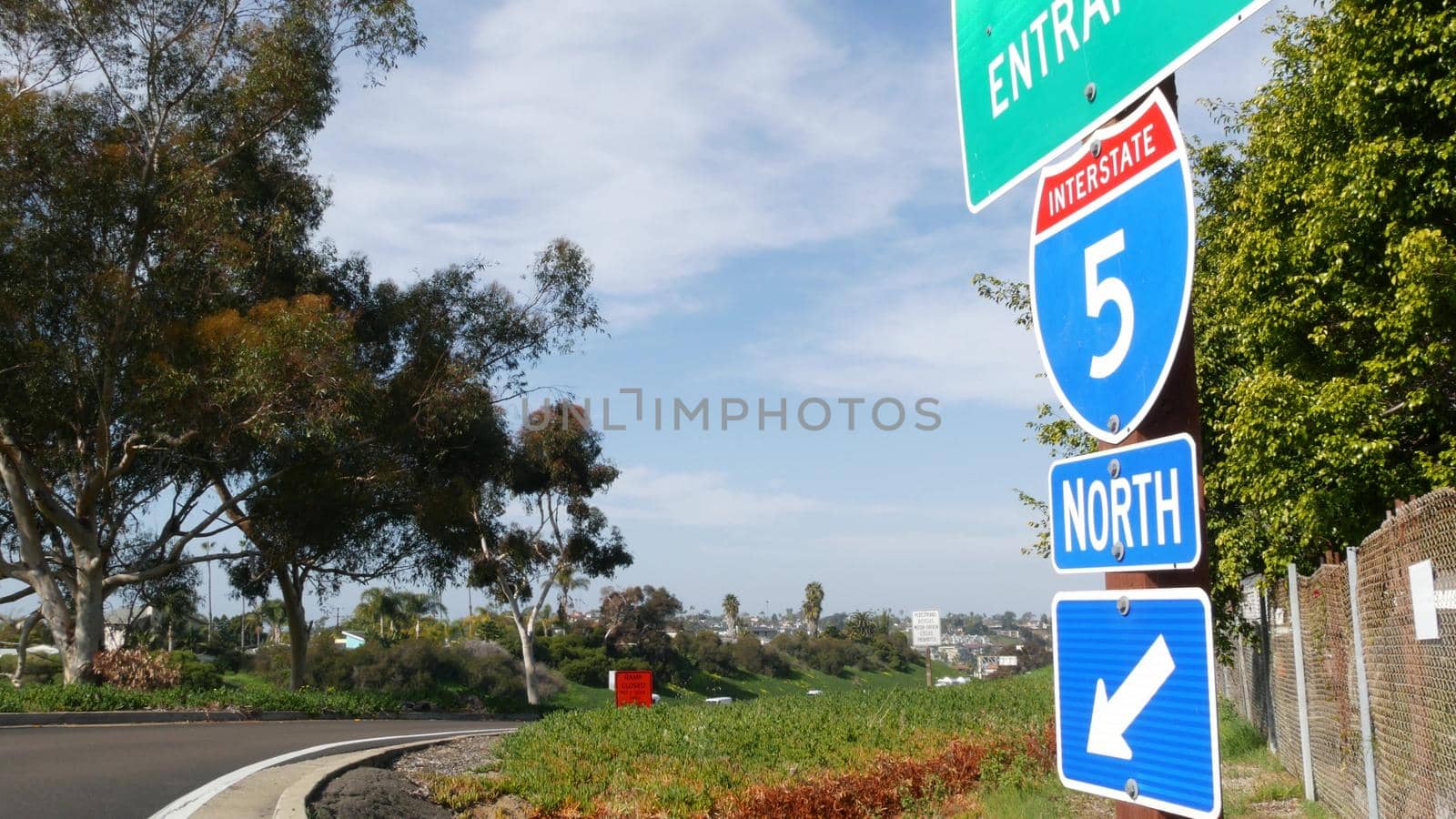 Freeway entrance, information sign on crossraod in USA. Route to Los Angeles, California. Interstate highway 5 signpost as symbol of road trip, transportation and traffic safety rules and regulations.